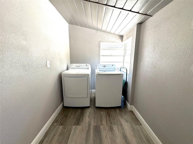 laundry area featuring separate washer and dryer, laundry area, wood finished floors, and a textured wall