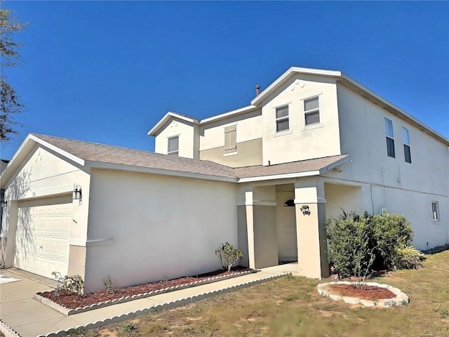 view of front of property featuring an attached garage and stucco siding