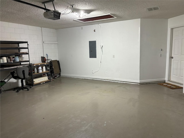 garage with visible vents, baseboards, electric panel, a garage door opener, and concrete block wall