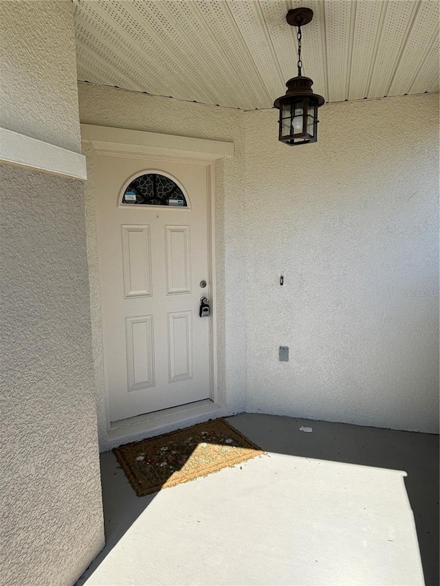 property entrance with stucco siding