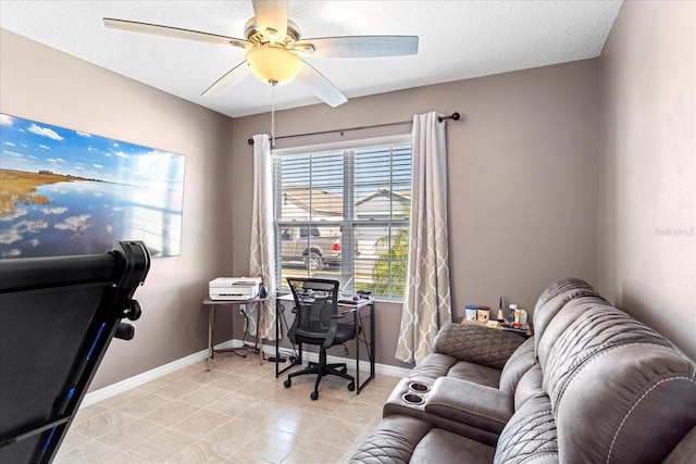 office area with a textured ceiling, baseboards, and ceiling fan