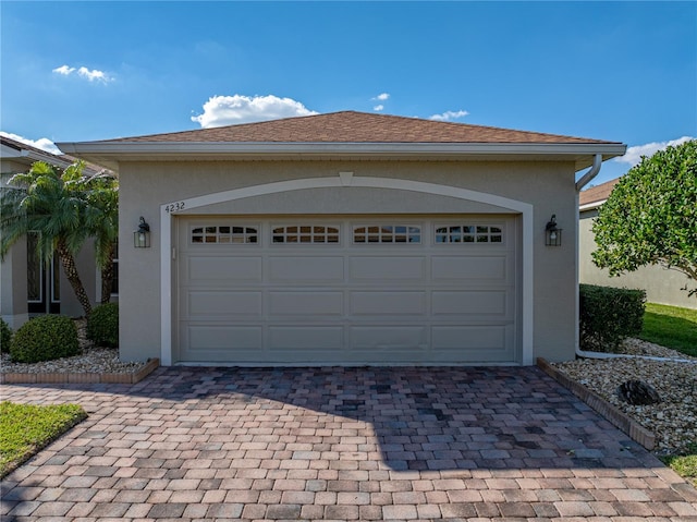 garage with decorative driveway