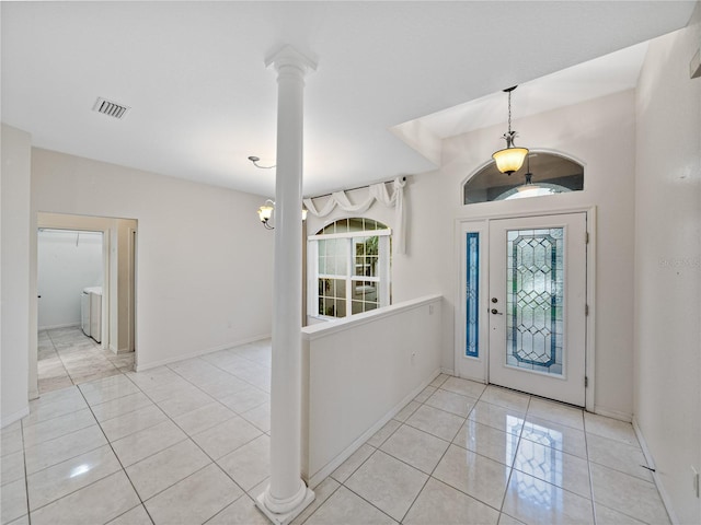 foyer featuring visible vents, washer / clothes dryer, decorative columns, and tile patterned floors