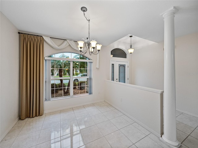 unfurnished dining area featuring ornate columns, tile patterned flooring, baseboards, and an inviting chandelier
