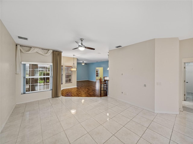 unfurnished room with light tile patterned flooring, visible vents, and a ceiling fan