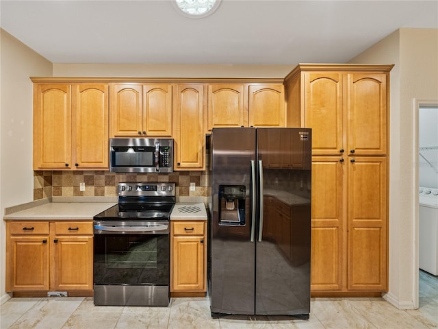 kitchen featuring marble finish floor, stainless steel appliances, tasteful backsplash, and light countertops