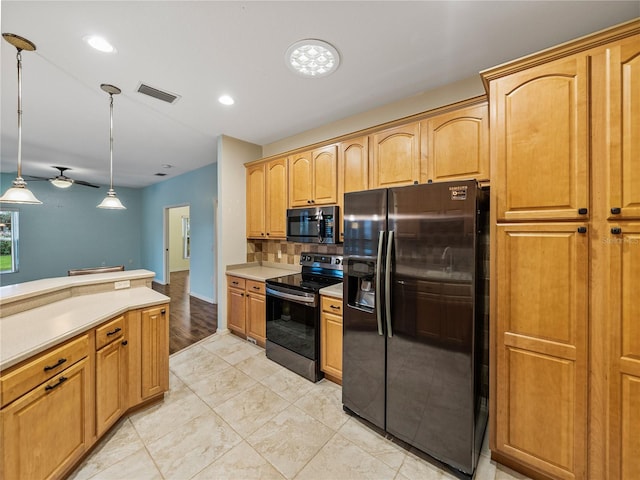 kitchen with decorative light fixtures, stainless steel electric stove, light countertops, visible vents, and black refrigerator with ice dispenser
