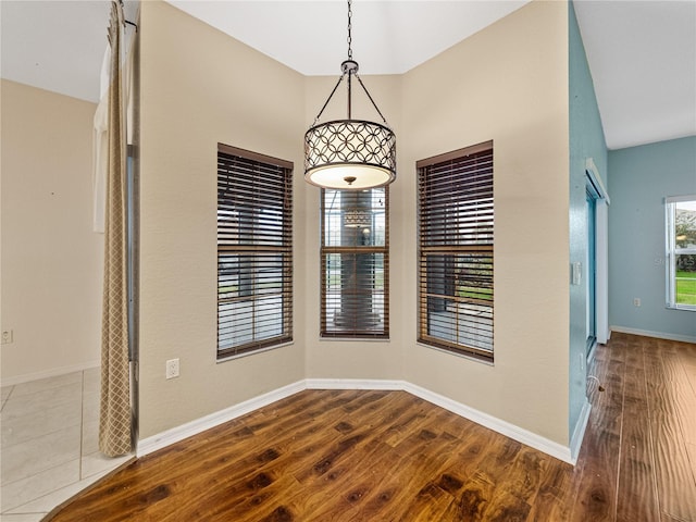 empty room with wood finished floors and baseboards