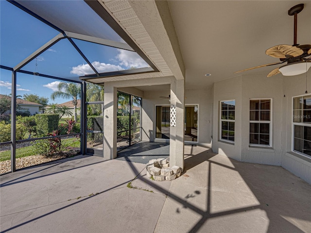 view of patio featuring ceiling fan and a lanai