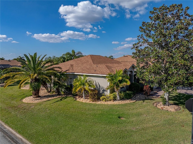 view of front facade featuring a front yard and stucco siding
