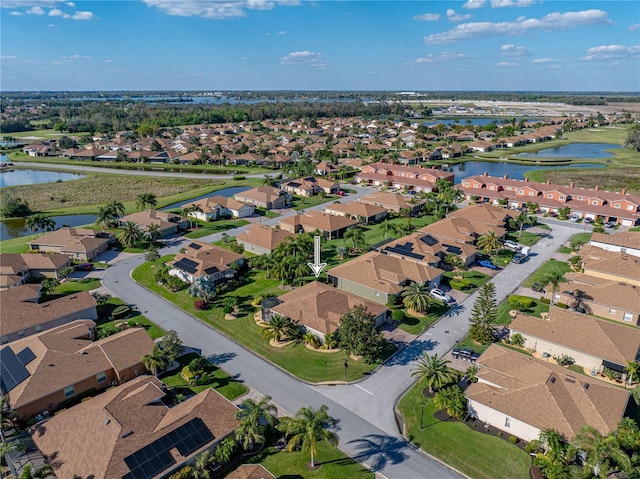 drone / aerial view with a residential view and a water view