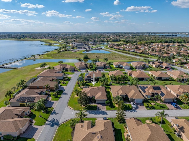 bird's eye view featuring a water view and a residential view