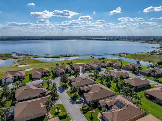 drone / aerial view with a residential view and a water view