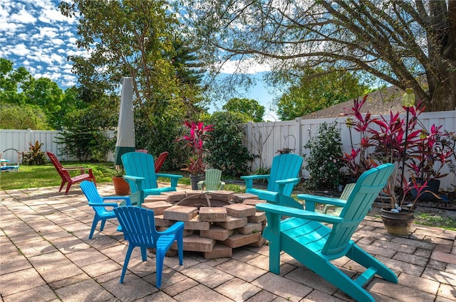 view of patio featuring a fenced backyard and an outdoor fire pit