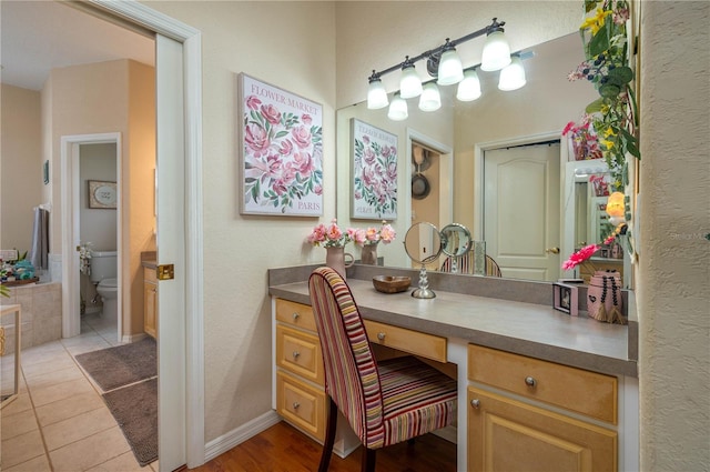 full bathroom with tile patterned floors, toilet, vanity, and baseboards