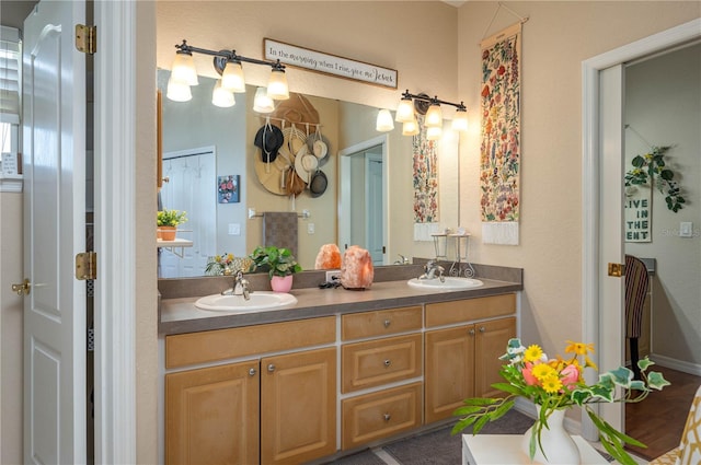 bathroom with a sink and double vanity