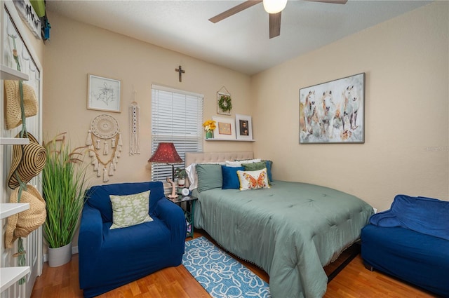 bedroom with ceiling fan and wood finished floors