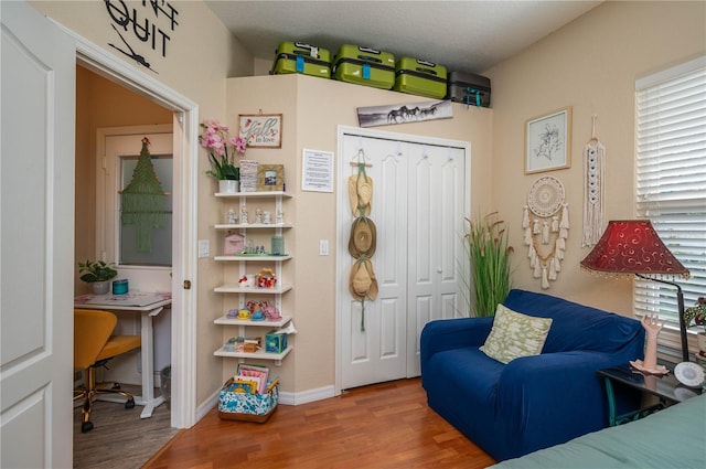 sitting room featuring baseboards and wood finished floors