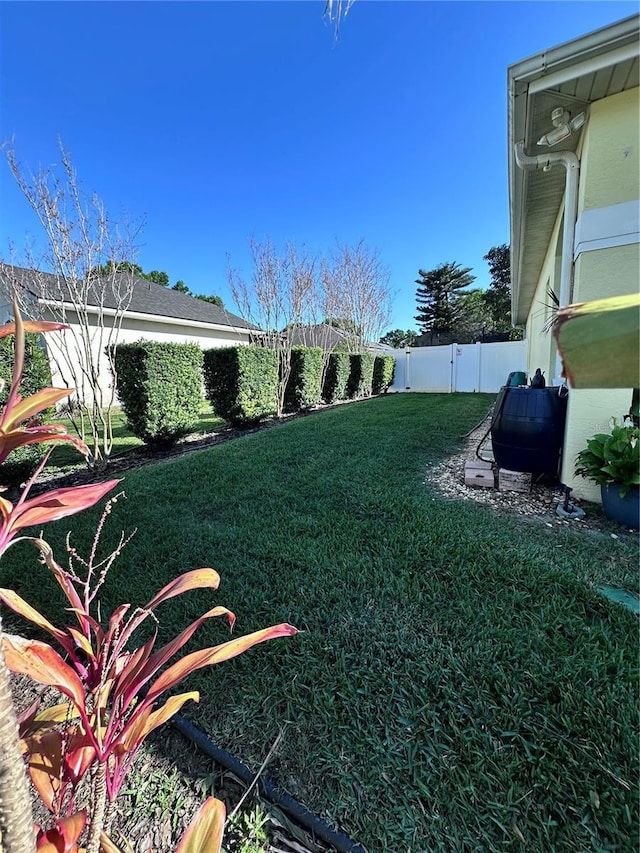 view of yard with a fenced backyard