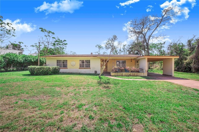 ranch-style house with concrete driveway, a front lawn, a carport, and stucco siding