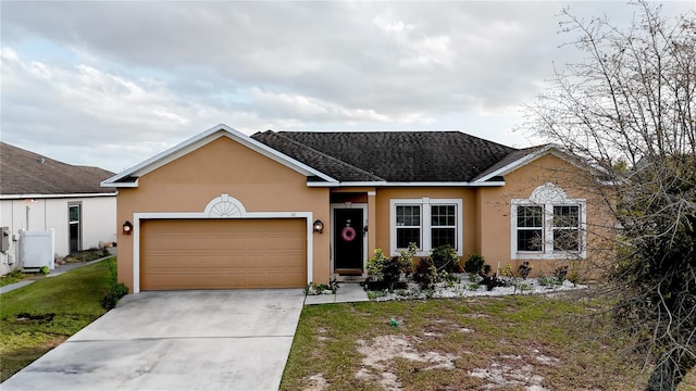 ranch-style house featuring stucco siding, a front lawn, roof with shingles, concrete driveway, and a garage