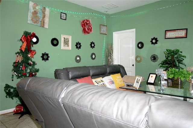 living room with visible vents, baseboards, and tile patterned flooring