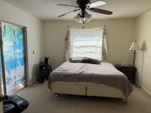 bedroom with carpet floors, access to outside, multiple windows, and a textured ceiling