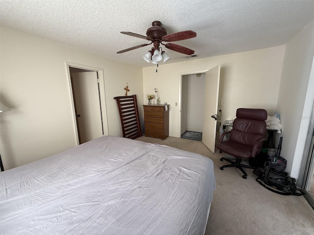 carpeted bedroom with a textured ceiling, ceiling fan, and visible vents