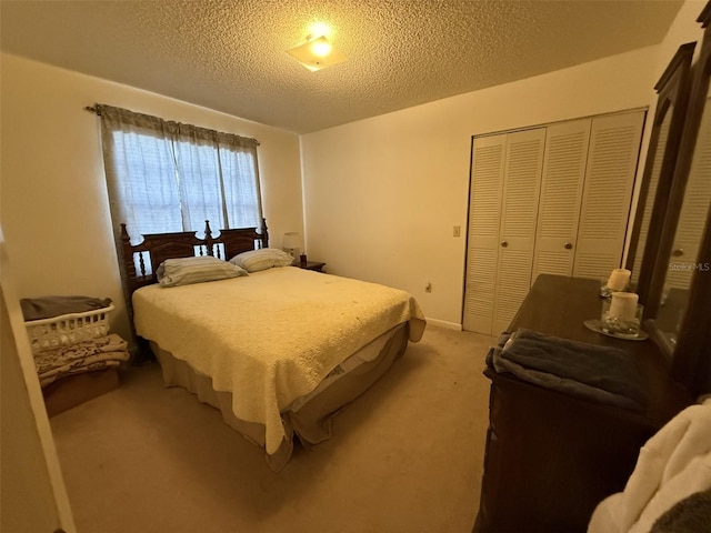 bedroom with a closet, carpet flooring, and a textured ceiling