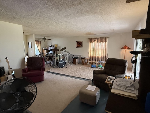 living area featuring a textured ceiling, carpet, and a ceiling fan