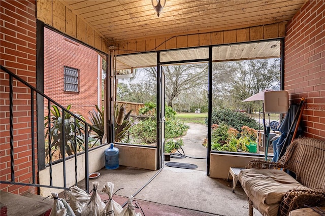 unfurnished sunroom featuring a wealth of natural light and wood ceiling