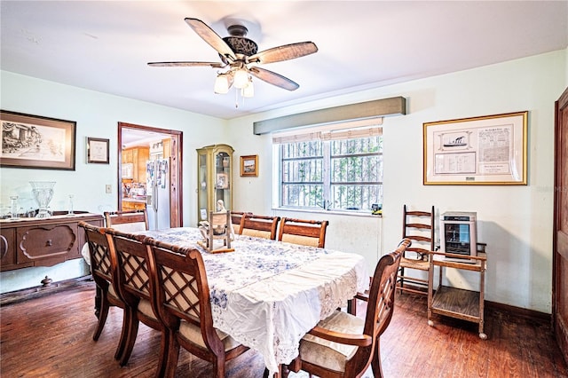 dining space featuring ceiling fan, baseboards, and wood finished floors