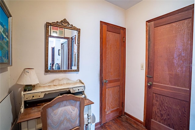 home office featuring baseboards and dark wood-style flooring