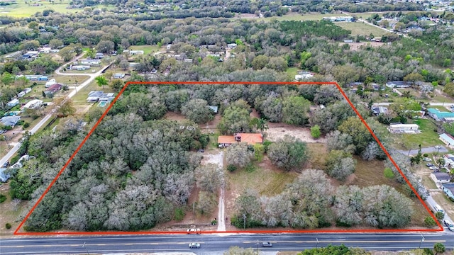 drone / aerial view featuring a view of trees