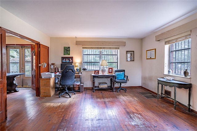 office space featuring a wealth of natural light, baseboards, hardwood / wood-style floors, and french doors