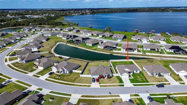 drone / aerial view with a residential view and a water view