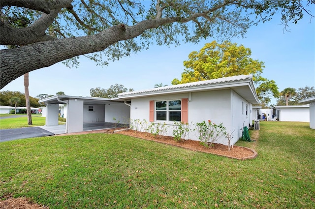 ranch-style house with a front lawn and stucco siding