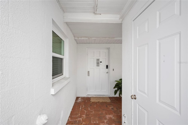 corridor featuring brick floor