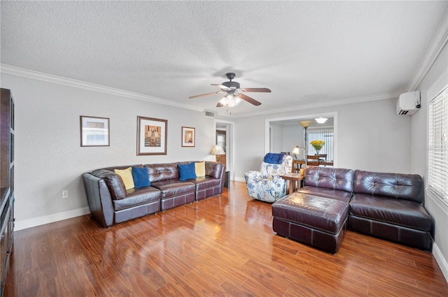 living room with a wealth of natural light, visible vents, an AC wall unit, and wood finished floors