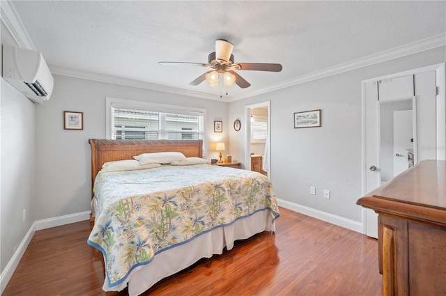 bedroom with ornamental molding, a wall unit AC, a textured ceiling, and wood finished floors