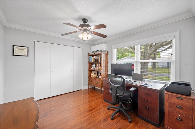 office space with ornamental molding, a wall mounted air conditioner, and wood finished floors