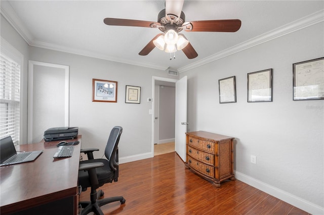 home office with ornamental molding, a ceiling fan, baseboards, and wood finished floors