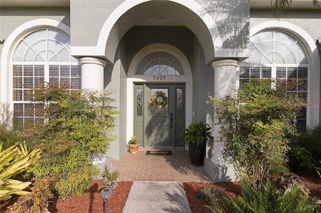 view of exterior entry featuring stucco siding