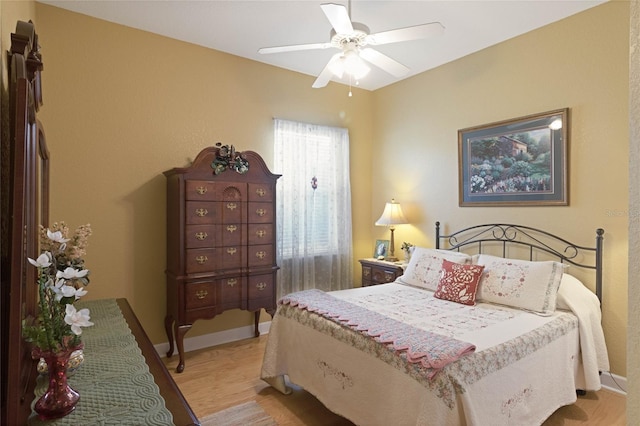 bedroom featuring light wood-type flooring, ceiling fan, and baseboards