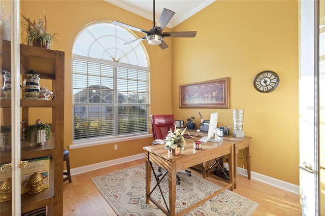 office featuring ornamental molding, wood finished floors, baseboards, and a ceiling fan