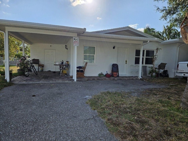 view of front of property with fence and stucco siding