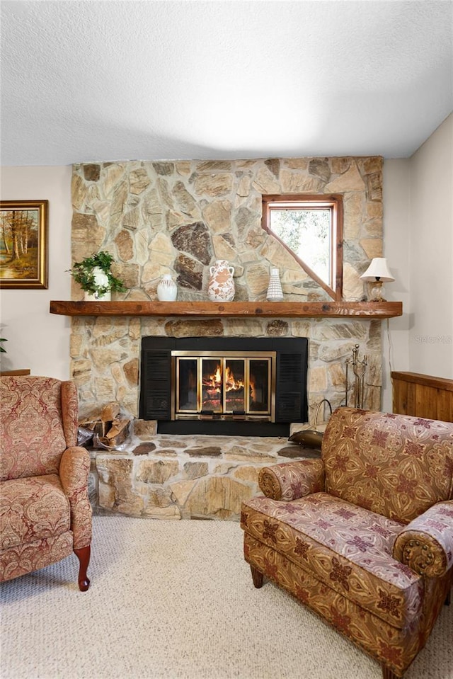 interior details featuring carpet, a fireplace, and a textured ceiling