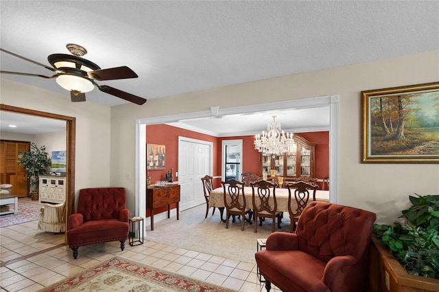 living room with light carpet, light tile patterned floors, ornamental molding, a textured ceiling, and ceiling fan with notable chandelier