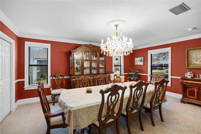 dining room with crown molding, visible vents, and light colored carpet