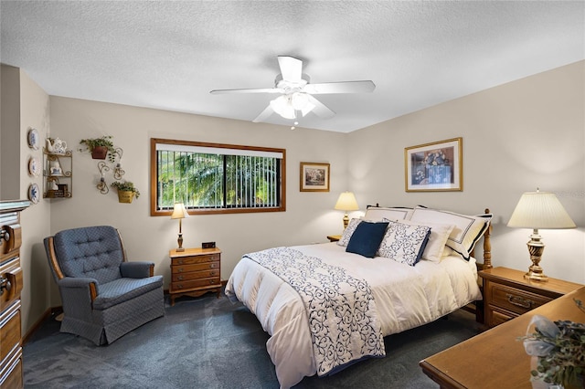 bedroom featuring dark carpet, a textured ceiling, and ceiling fan